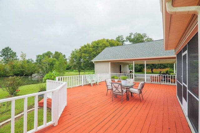 wooden terrace featuring a yard