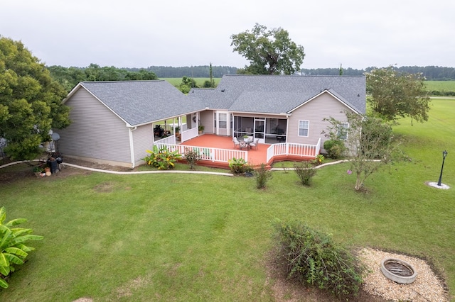 back of house with a lawn, a deck, and a sunroom