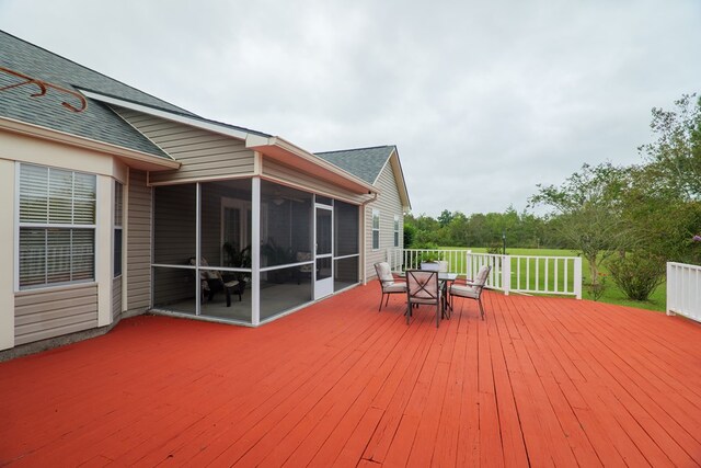 wooden deck with a sunroom