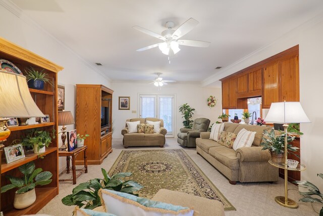 living room featuring ceiling fan, light colored carpet, and crown molding