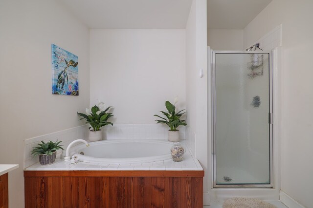 bathroom with vanity and independent shower and bath