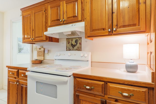 kitchen featuring white electric range and light tile patterned floors