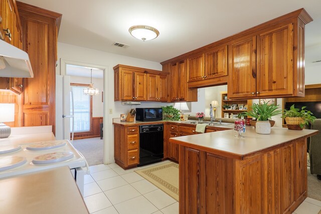 kitchen featuring an inviting chandelier, light carpet, kitchen peninsula, hanging light fixtures, and black appliances