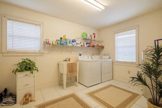 laundry area featuring separate washer and dryer and light tile patterned floors