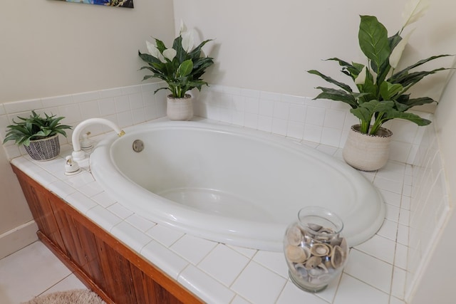 bathroom with tile patterned flooring and a bath