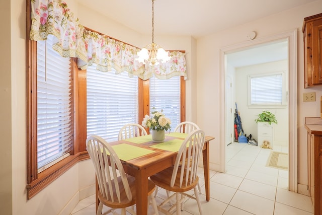 dining room with light tile patterned flooring, a chandelier, and a wealth of natural light