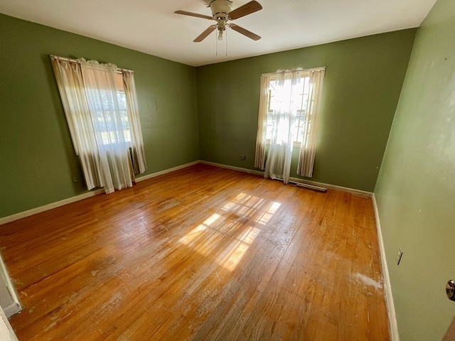 unfurnished room with ceiling fan and light wood-type flooring