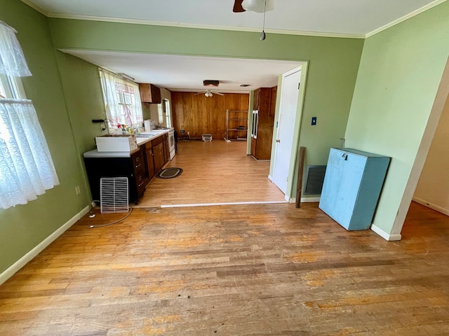 kitchen featuring white electric range, light wood-type flooring, ceiling fan, and ornamental molding