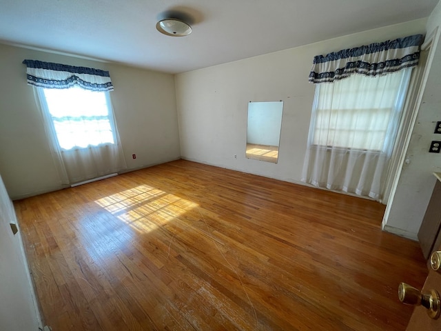 unfurnished room with light hardwood / wood-style flooring