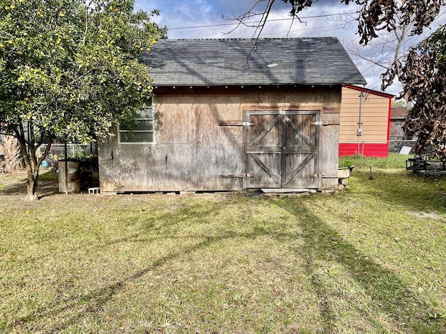 view of outdoor structure featuring a lawn