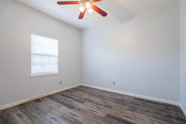 spare room featuring dark hardwood / wood-style floors and ceiling fan