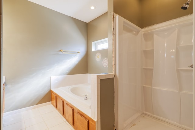 bathroom featuring tile patterned floors and shower with separate bathtub