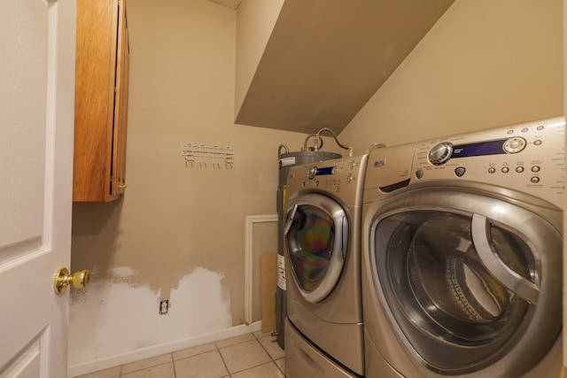 laundry room with light tile patterned flooring and washer and clothes dryer