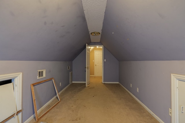 bonus room featuring light colored carpet and lofted ceiling