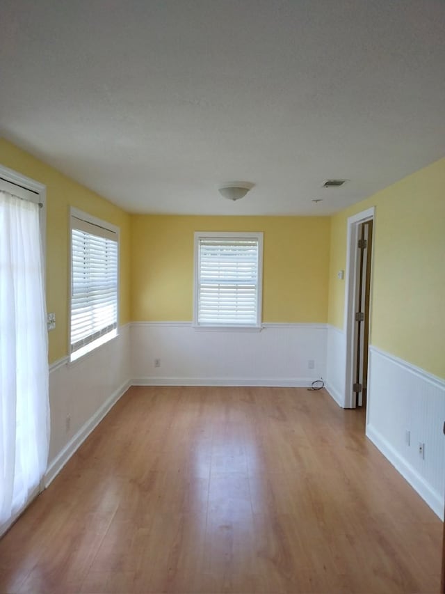 unfurnished room with light hardwood / wood-style flooring