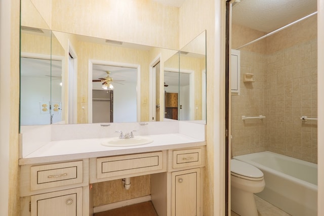 bathroom with toilet, vanity, visible vents, ceiling fan, and tile patterned flooring