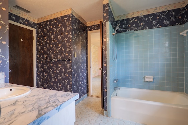 bathroom with vanity, visible vents, tile patterned flooring, washtub / shower combination, and wallpapered walls