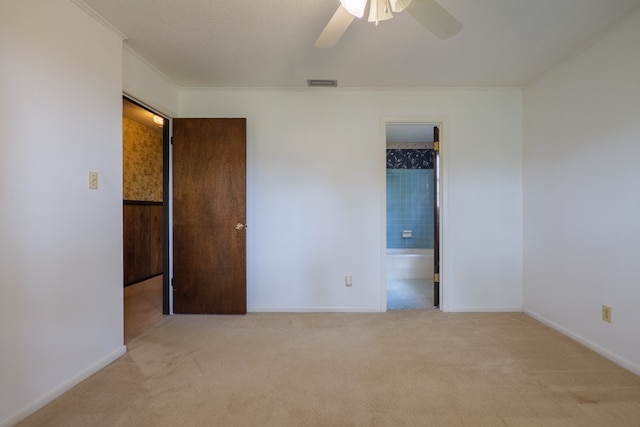 unfurnished bedroom featuring carpet, baseboards, and visible vents