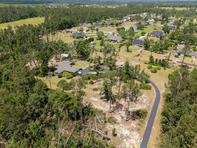 aerial view featuring a forest view and a residential view