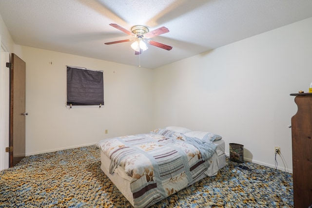carpeted bedroom with baseboards and a ceiling fan