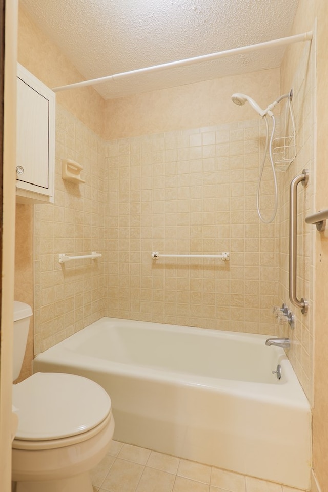 bathroom featuring shower / bath combination, tile patterned flooring, toilet, and a textured ceiling