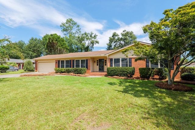 ranch-style home featuring a garage, concrete driveway, a front lawn, and brick siding