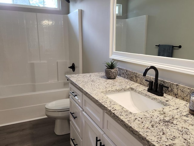 full bathroom featuring toilet, vanity, tub / shower combination, and hardwood / wood-style flooring