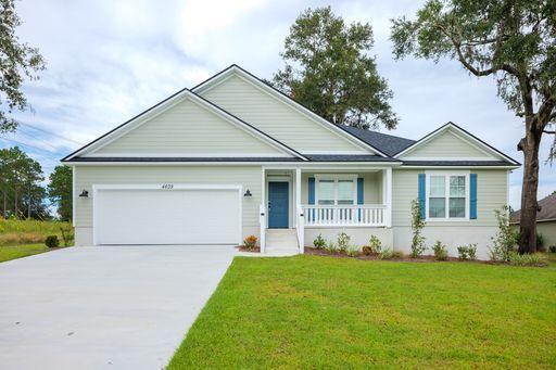 ranch-style home with a porch, a garage, and a front yard