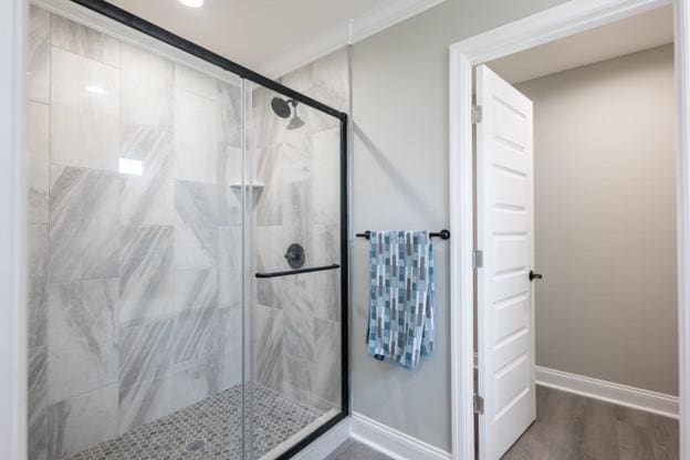 bathroom featuring an enclosed shower and hardwood / wood-style flooring