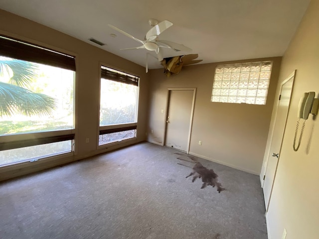 spare room featuring ceiling fan and light colored carpet