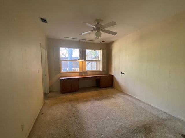 carpeted empty room featuring ceiling fan