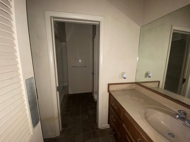 bathroom with tile patterned flooring, vanity, and toilet