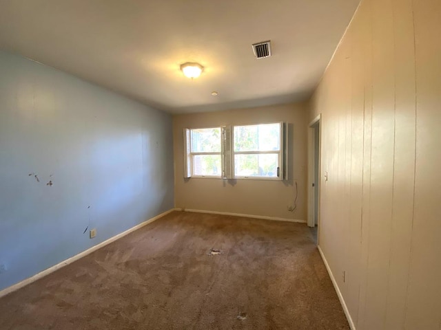 empty room featuring dark carpet