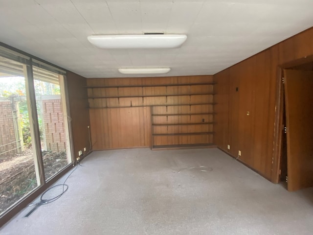 unfurnished room with wood walls