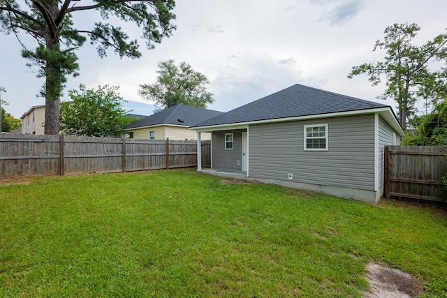 back of house with a lawn