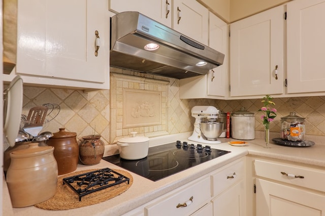 303 Breckenridge Dr, Valdosta, GA 31605 - kitchen featuring under cabinet range hood, white cabinetry, light countertops, and tasteful backsplash