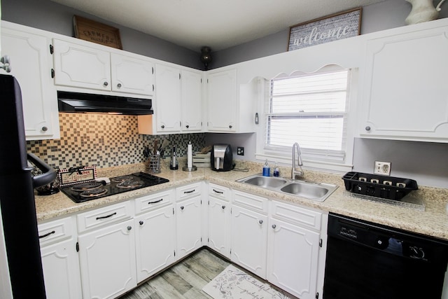 kitchen featuring tasteful backsplash, sink, black appliances, light hardwood / wood-style flooring, and white cabinetry