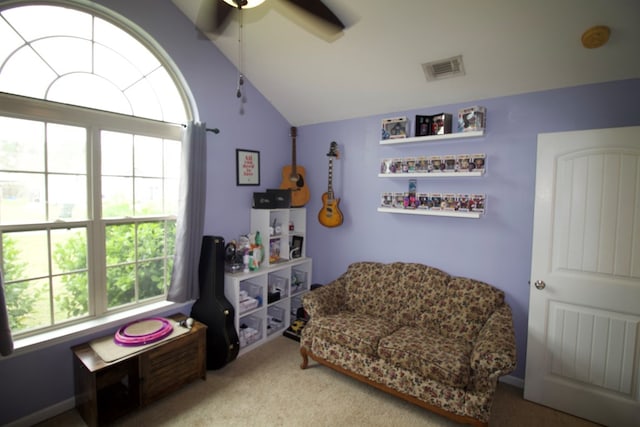 interior space featuring lofted ceiling, carpet floors, ceiling fan, and visible vents