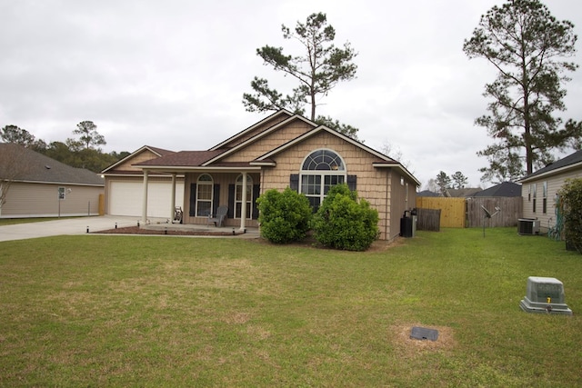 view of front of property with central air condition unit, a garage, fence, concrete driveway, and a front lawn