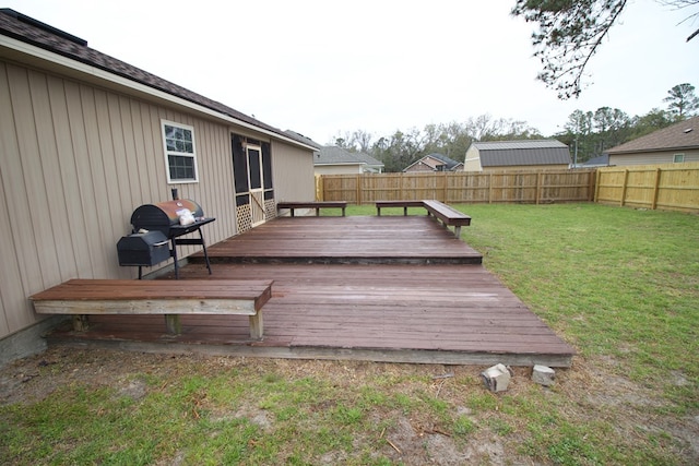 deck with a lawn, area for grilling, and a fenced backyard