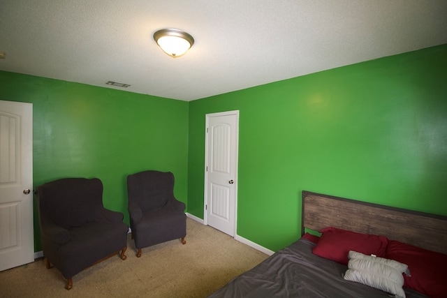 carpeted bedroom with visible vents and baseboards