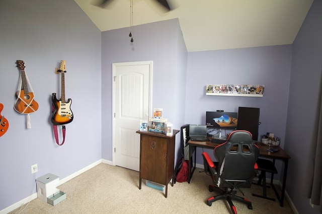 carpeted office featuring lofted ceiling and baseboards