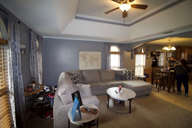 living room with arched walkways, crown molding, a raised ceiling, visible vents, and tile patterned floors