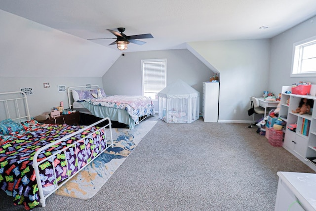 carpeted bedroom featuring baseboards, lofted ceiling, and a ceiling fan