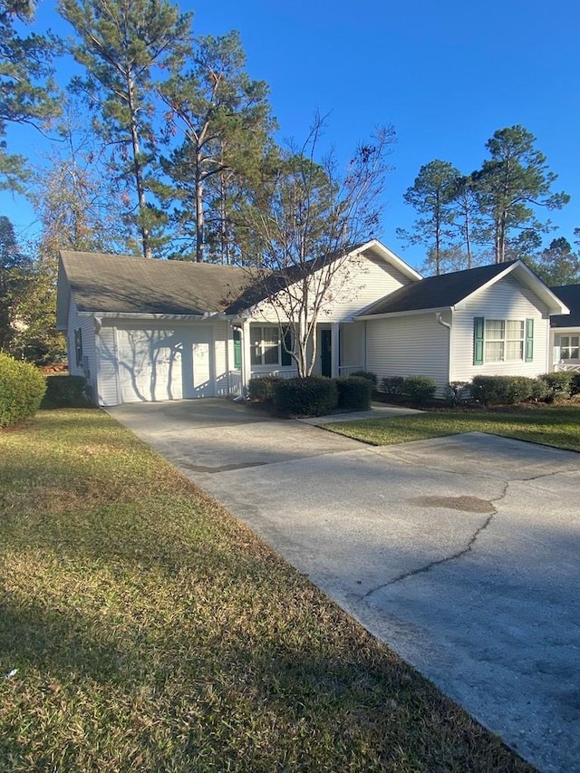 ranch-style house featuring a garage and a front yard