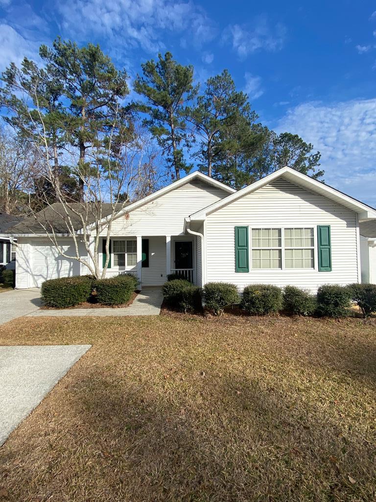 single story home featuring a garage and a front yard