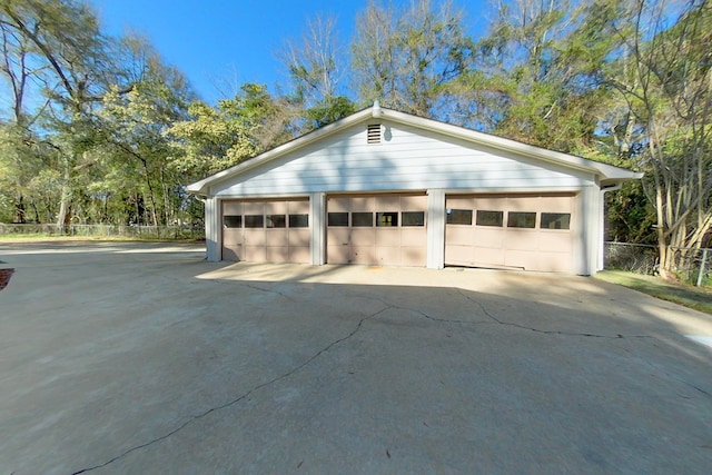 detached garage featuring fence