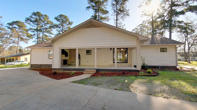 view of front of property with crawl space and roof with shingles