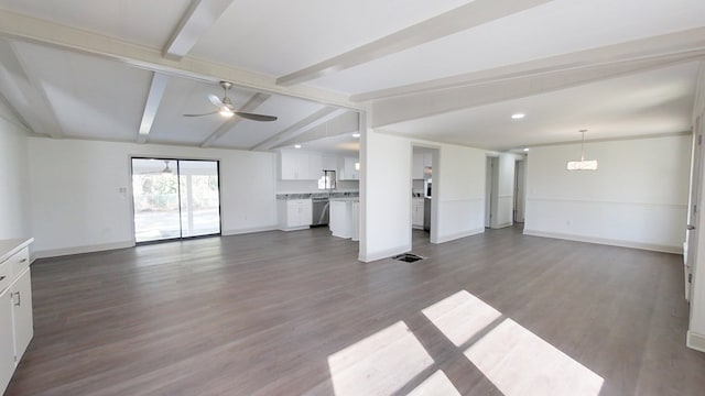 unfurnished living room featuring baseboards, dark wood-type flooring, a ceiling fan, and vaulted ceiling with beams