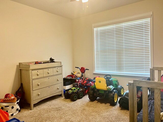 rec room with carpet floors and ceiling fan